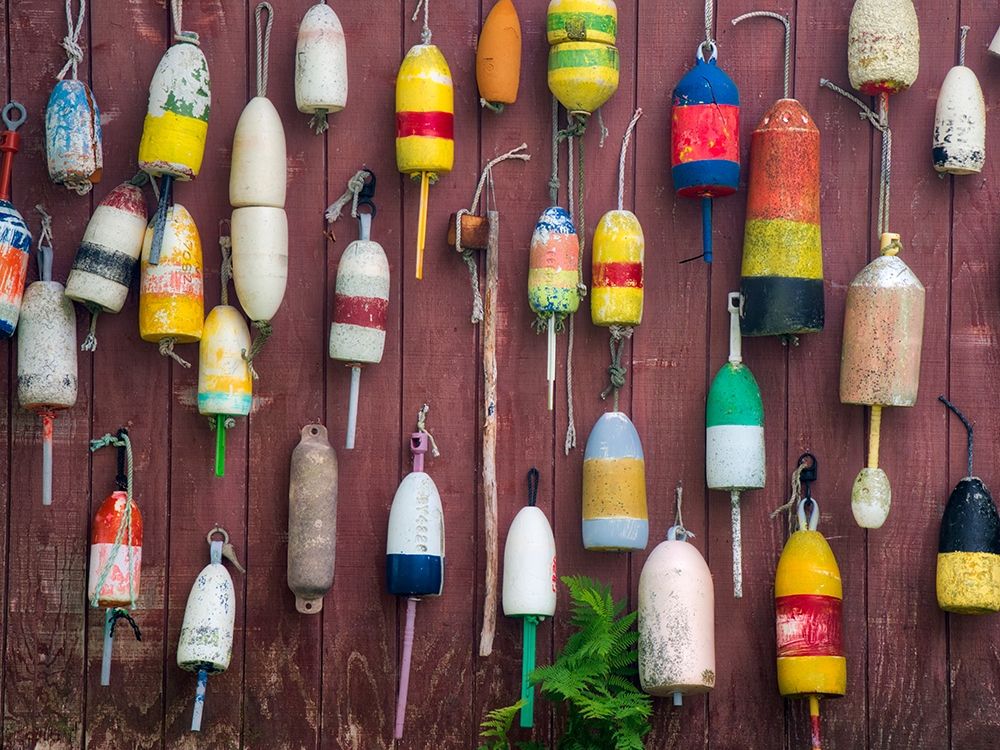 Maine Colorful buoys hanging on the exterior of a building